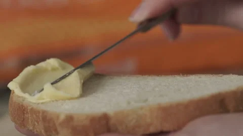 Butter on white bread Stock Footage 87991396
