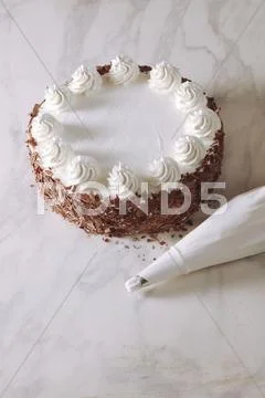 Buttercream Cake With Grated Chocolate, Piping Bag Beside It