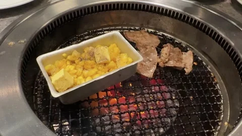 Buttered Corn Cooking Over Flames on Korean BBQ Grill Stock Footage 346139737