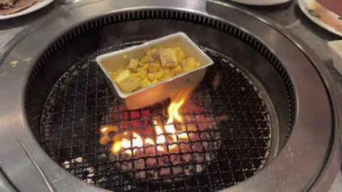 Buttered Corn Cooking Over Flames on Korean BBQ Grill Stock Footage 346146346