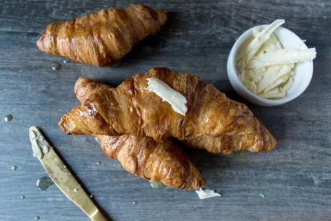 Buttered croissant rolls on rustic table top view Stock Photos
