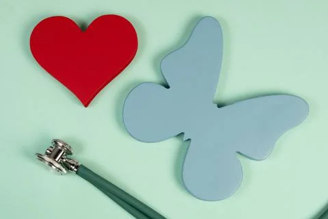 Butterfly symbolizing the thyroid and the shape of a heart Stock Photos