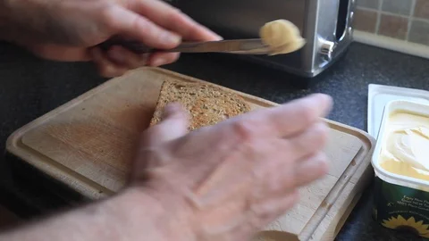 Buttering Brown Toast Stock Footage 128796471