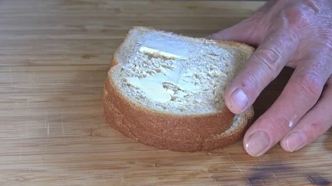 Buttering a slice of bread Stock Footage 82243353