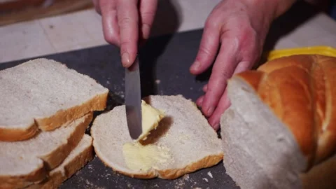 Buttering a slice of freshly sliced white bread Stock Footage 166468507