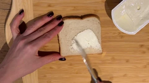 Buttering a Slice of White Bread for a Sandwich Stock Footage 328059307
