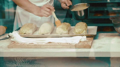 Buttering strudels for baking Stock Footage 82041163