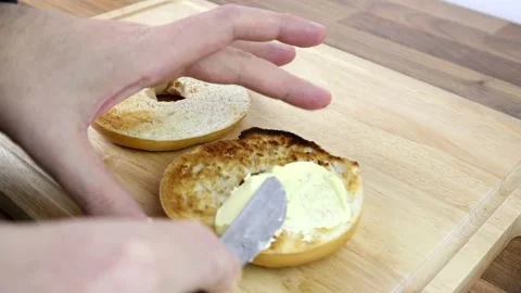 Buttering a toasted bagel Stock-Footage 135241216