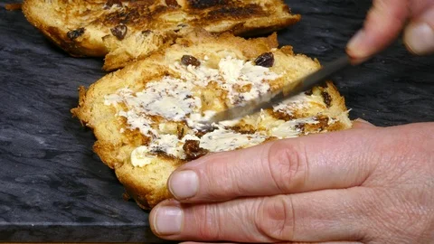 Buttering toasted panettone bread. Stock Footage 122076870