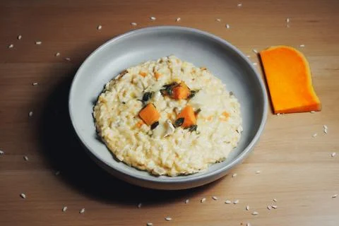 Butternut squash risotto topped with fresh herbs 스톡 사진