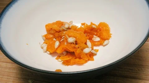 Butternut Squash Squash Seeds Drop into a Ceramic Bowl in 4k Stock Footage 86255095