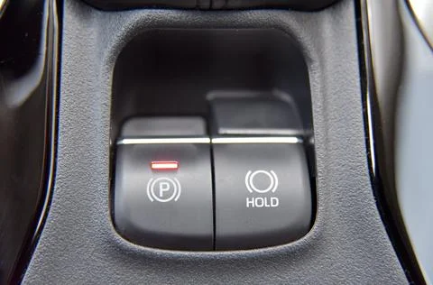 Button to activate the electric parking brake on the car Stock Photos
