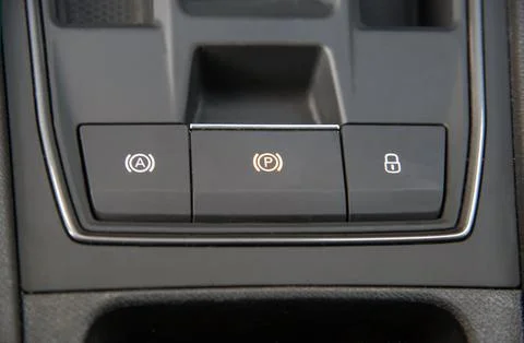 Button to activate the electric parking brake on the car Stock Photos