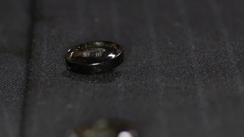 Button being measured by tailor on blue stripped fabric. A buttoned suit when Stock Footage 126498371