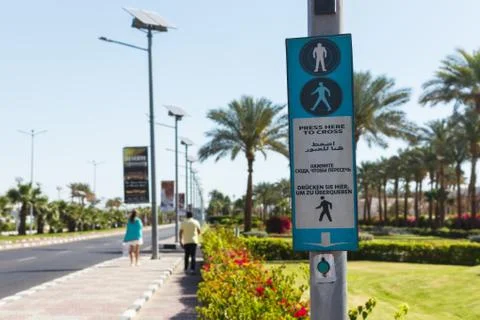 Button for calling the pedestrian crossing with the up arrow. click here to c Stock Photos