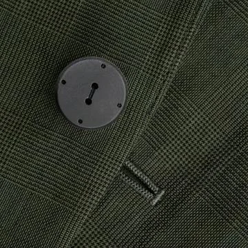 Button on the checkered dark green jacket Stock Photos