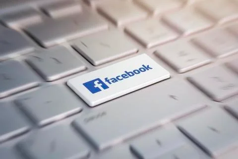 Button with the company logo facebook on the grey keyboard of a modern laptop Stock Photos