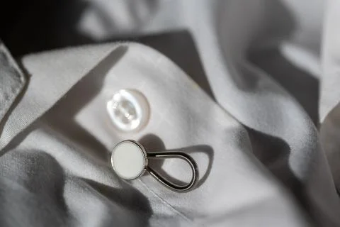 Button extender shown on a white dress shirt to increase size Stock Photos
