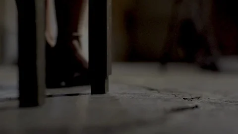 Button falling to the floor with women sat down, just the shoes Video stock 128785339