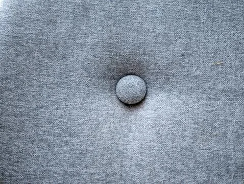 Button on Gray Fabric: Single Round Fastener on Soft Cloth Material Close-u.. 스톡 사진
