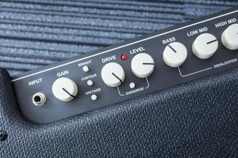 Button of Guitar Power Amplifier, closeup view background Stock Photos