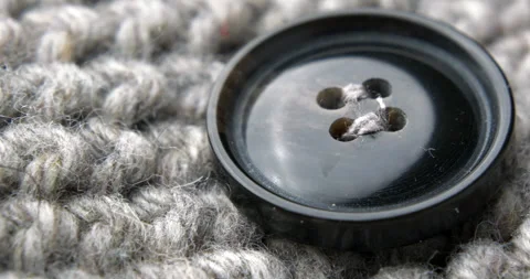 Button on a knitted cardigan Stock Footage 273814437