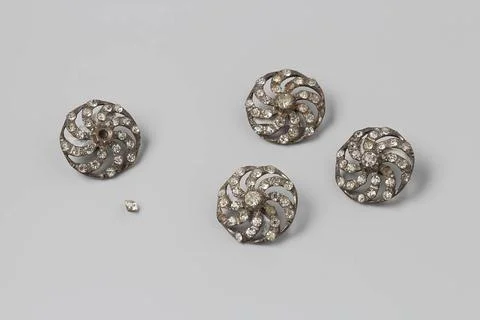 Button with a large stone in the middle around which eight small on curved... Stock Photos