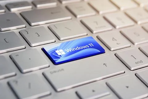 Button with the logo Windows 11 on the grey keyboard of a modern laptop. Stock Photos