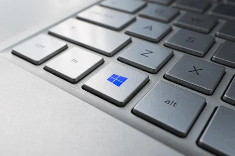 Button with the logo Windows on the grey keyboard of a modern laptop. Stock Photos