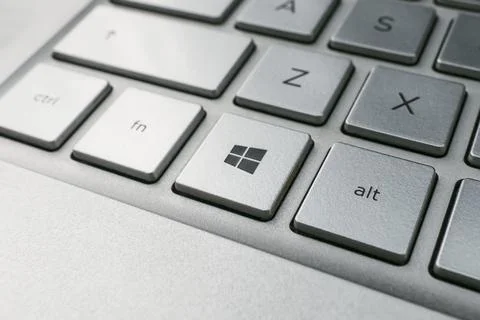 Button with the logo Windows on the grey keyboard of a modern laptop. Stock Photos