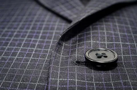 A button on a man's suit close-up. Element of men's clothing. Buttons Foto stock