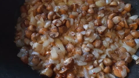 Button mushrooms with onion during frying in cooking oil Stock Footage 209148979