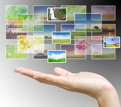 Button over a hand on gray background Stock Photos