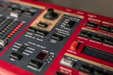 Button panel of a classic red stage synthesizer, with various controls and di Stock Photos