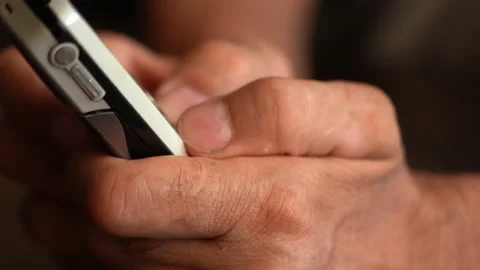 A button phone in the wrinkled hands of an elderly person Stock Footage 201663246