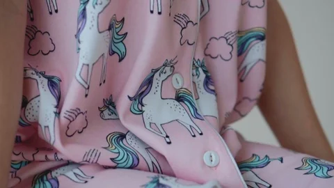 Button on pink pajamas close-up Stock Footage 126666990