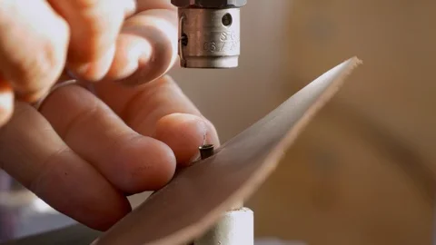 Button press detail Close up, adding button to leather Stockbeeldmateriaal 118136045