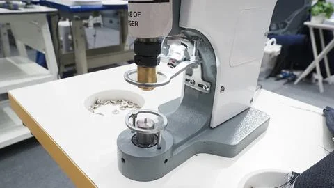 A button press machine used in garment manufacturing Foto stock