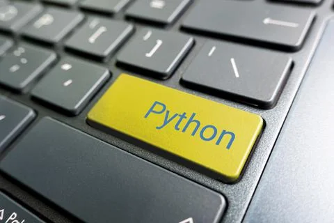 Button with the python on the yellow keyboard of modern laptop. Stock Photos