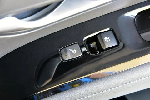 The button for raising the windows and the button for heating the seats Stock Photos