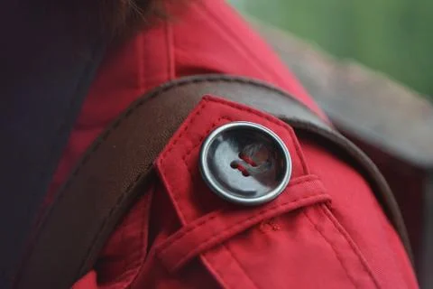 Button on a red coat decorating outerwear Stock Photos