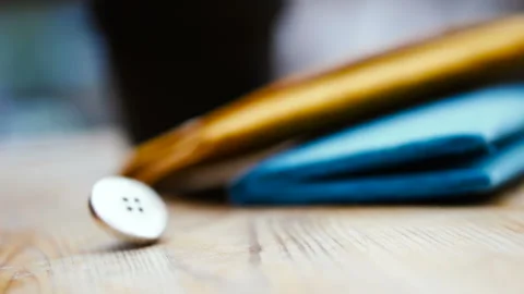 Button for sewing. Button spin on the table Stock Footage 101126489