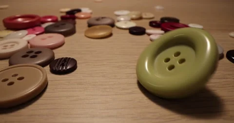 Button for sewing. Button spin on the table. Stock Footage 168248994