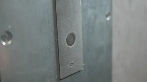 A button on a shiny minimalistic steel panel is being pressed. Stock Footage 300706664