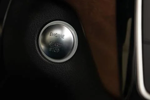 Button start and turn off the ignition of the car engine close-up on the dash 스톡 사진