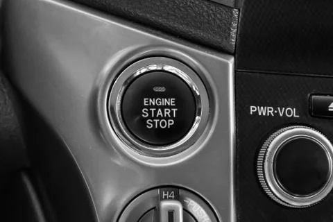 Button start and turn off the ignition of the car engine close-up on the dash 스톡 사진