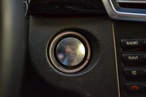 Button start and turn off the ignition of the car engine close-up on the dash 스톡 사진