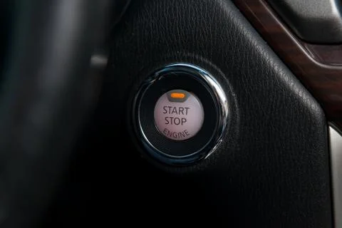 Button start and turn off the ignition of the car engine close-up on the dash Stock Photos