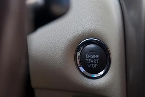 Button start and turn off the ignition of the car engine close-up on the dash Stock Photos