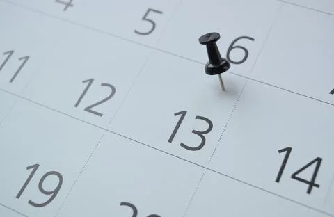 A button stuck into an open calendar Stock Photos